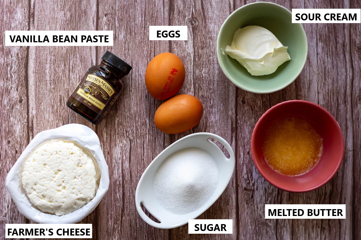 Ingredients for Lithuanina farmer's cheese filling for the crumble on a wooden surface.