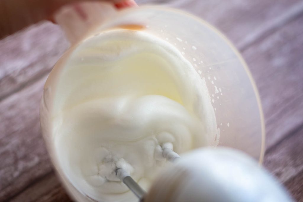 Whisking egg whites in a jug.