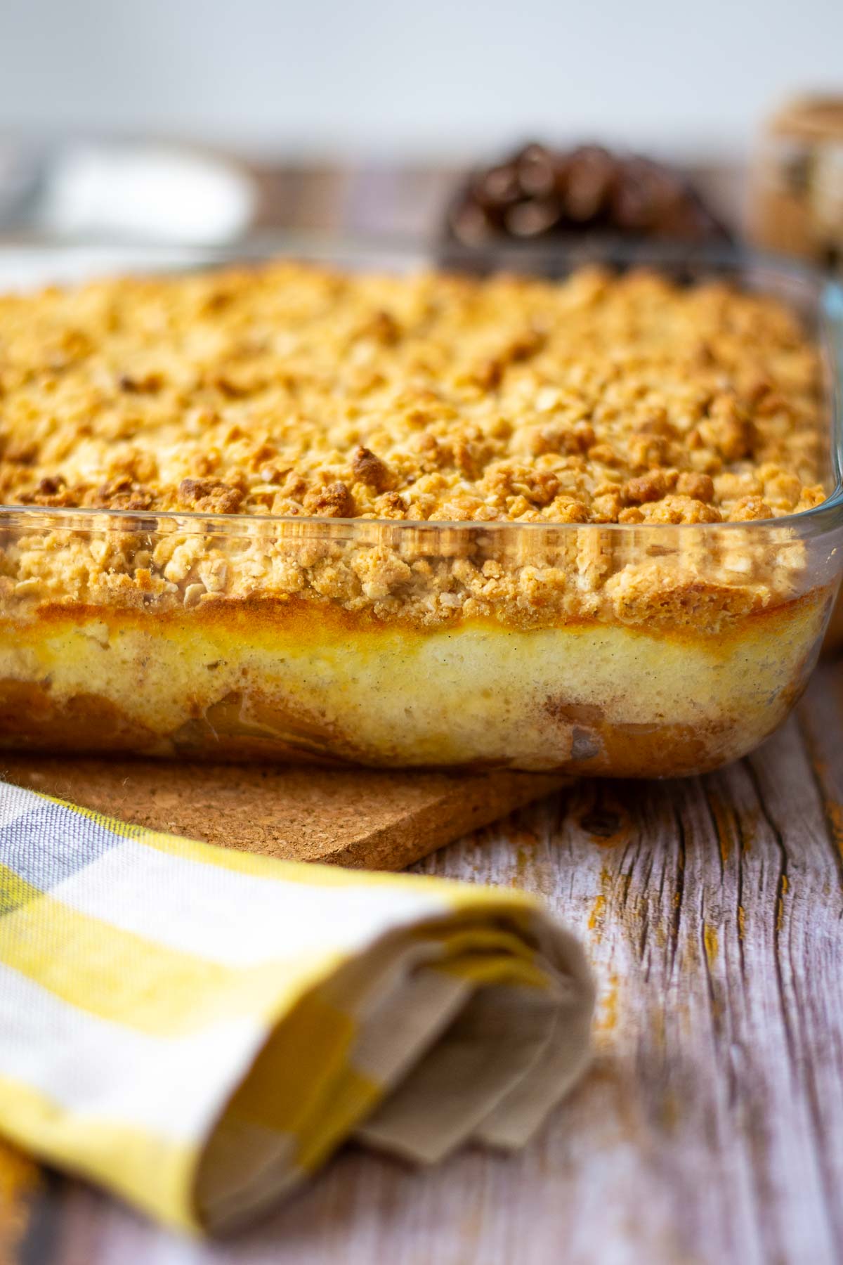 Baked Lithuanian apple and farmers cheese crumble on a wooden table.