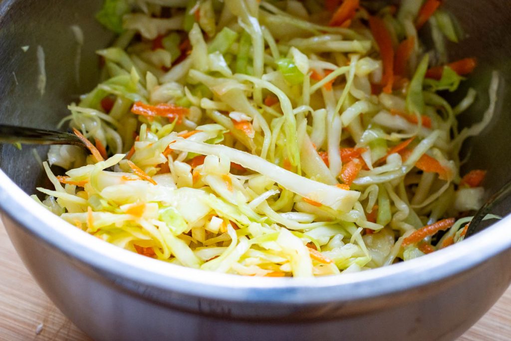 Lithuanian cabbage slaw mixed in a large metal bowl.