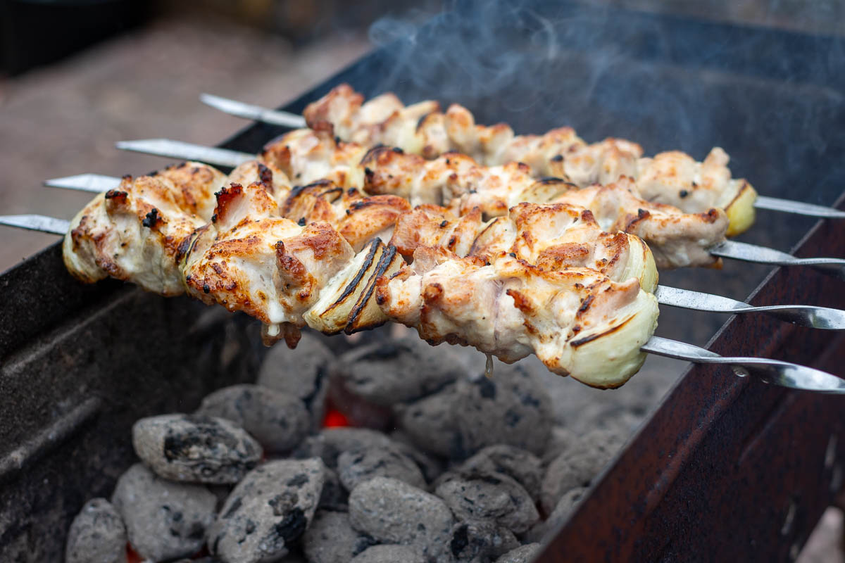 Lithuanian Chicken thigh shashlik on a coal grill.