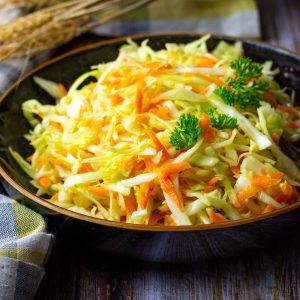 Lithuanian Cabbage Slaw without mayo in a black bowl.