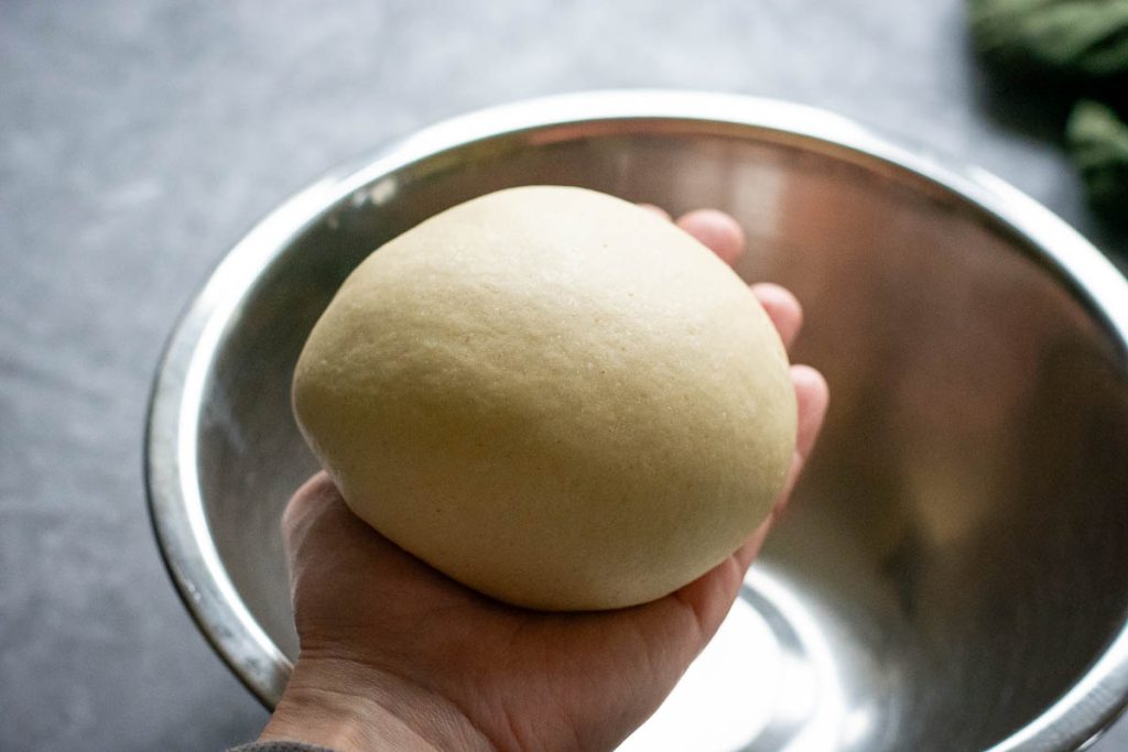 A ball of dough being placed in a ball.