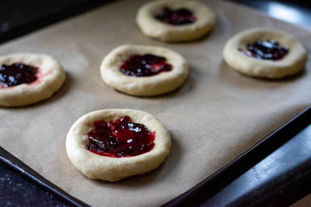 Jam spread on the bun dough.