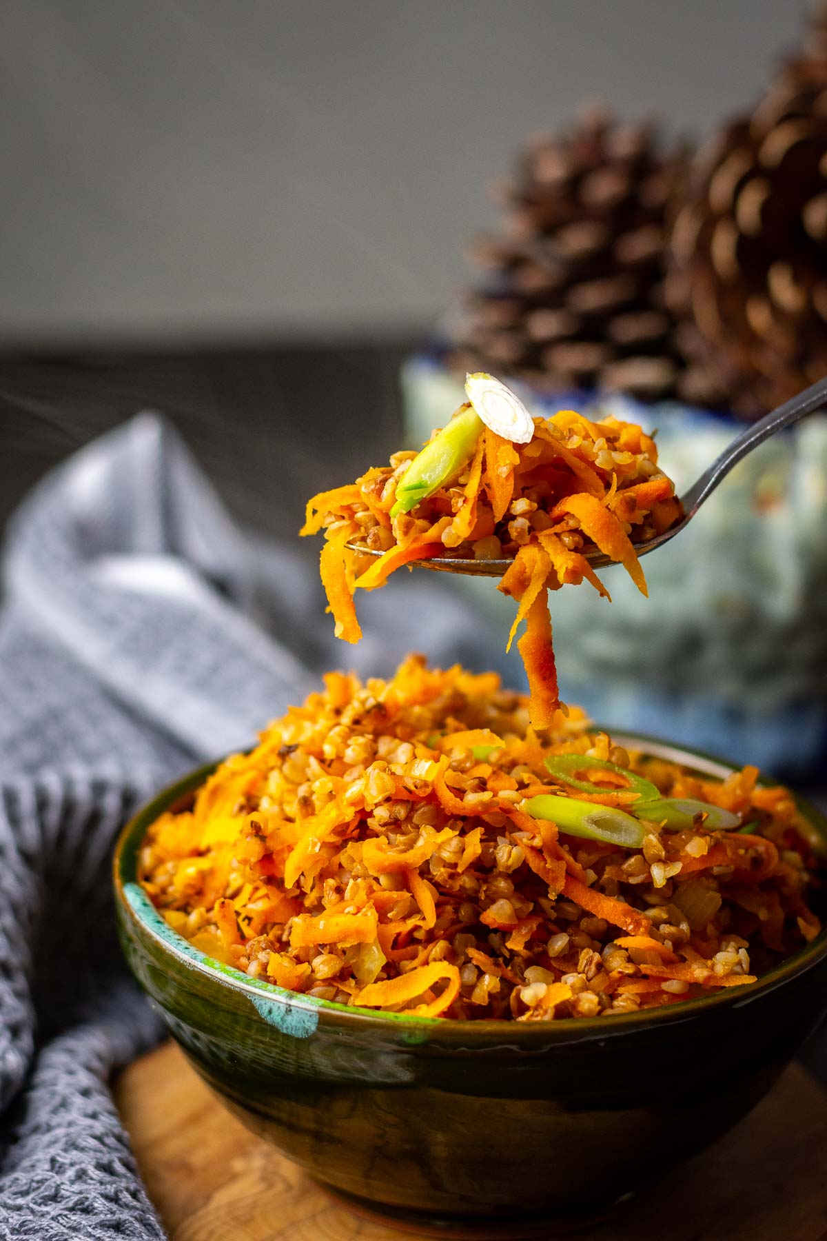 Lithuanian Buckwheat with carrots and onion being picked up by a spoon.