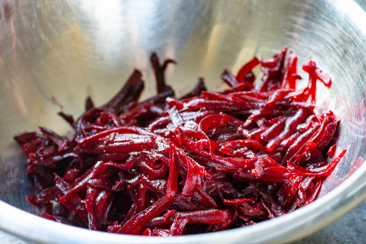 Grated beetroot in a metal bowl.