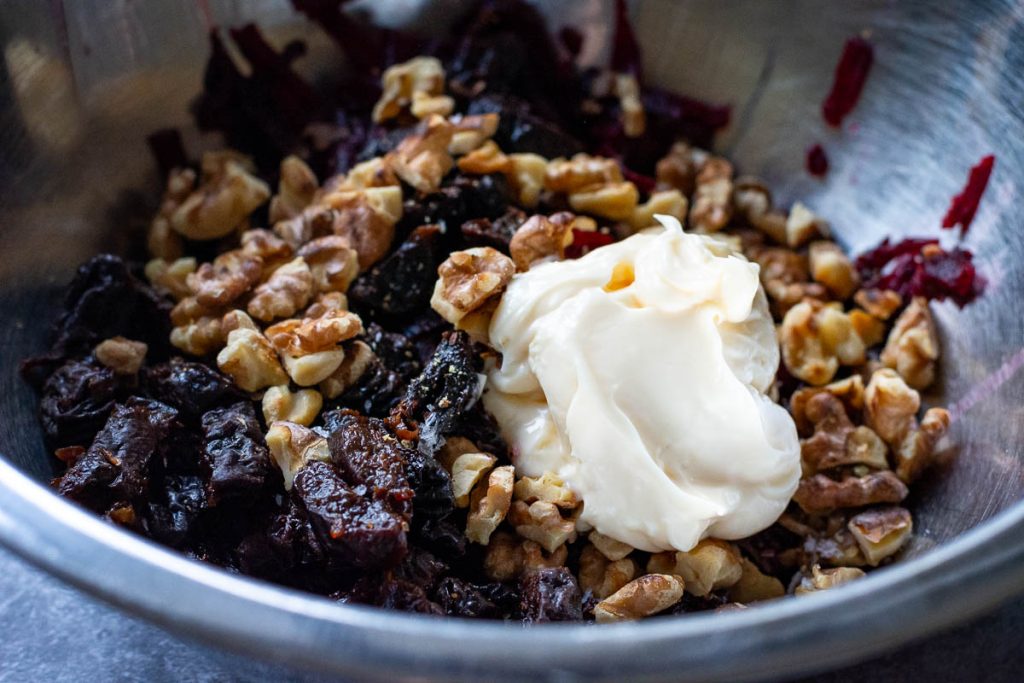 Lithuanian beetroot salad ingredients in a mixing bowl.