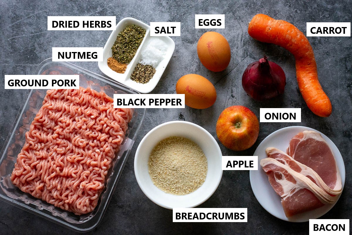 Ingredients for meatloaf with apples on grey surface.