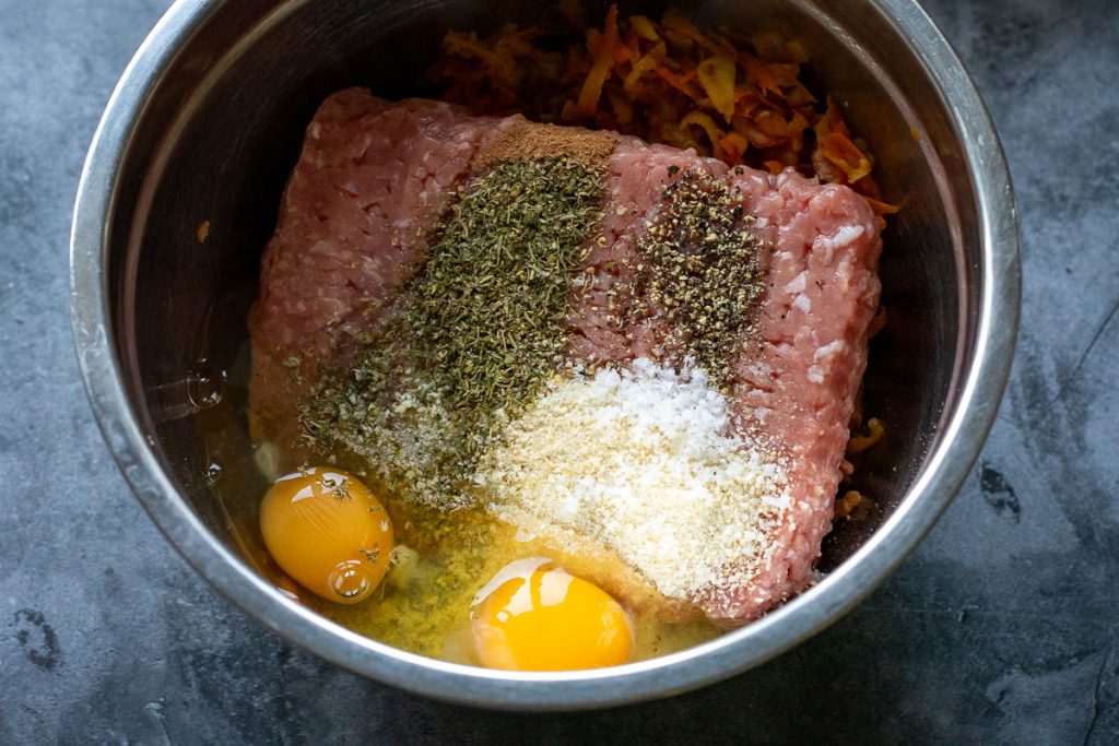 Ground pork, seasoning and eggs in a large mixing bowl.