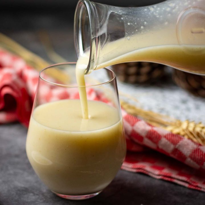 Oat Kissel being poured from a carafe into a glass on a Christmas Eve table in Lithuania.