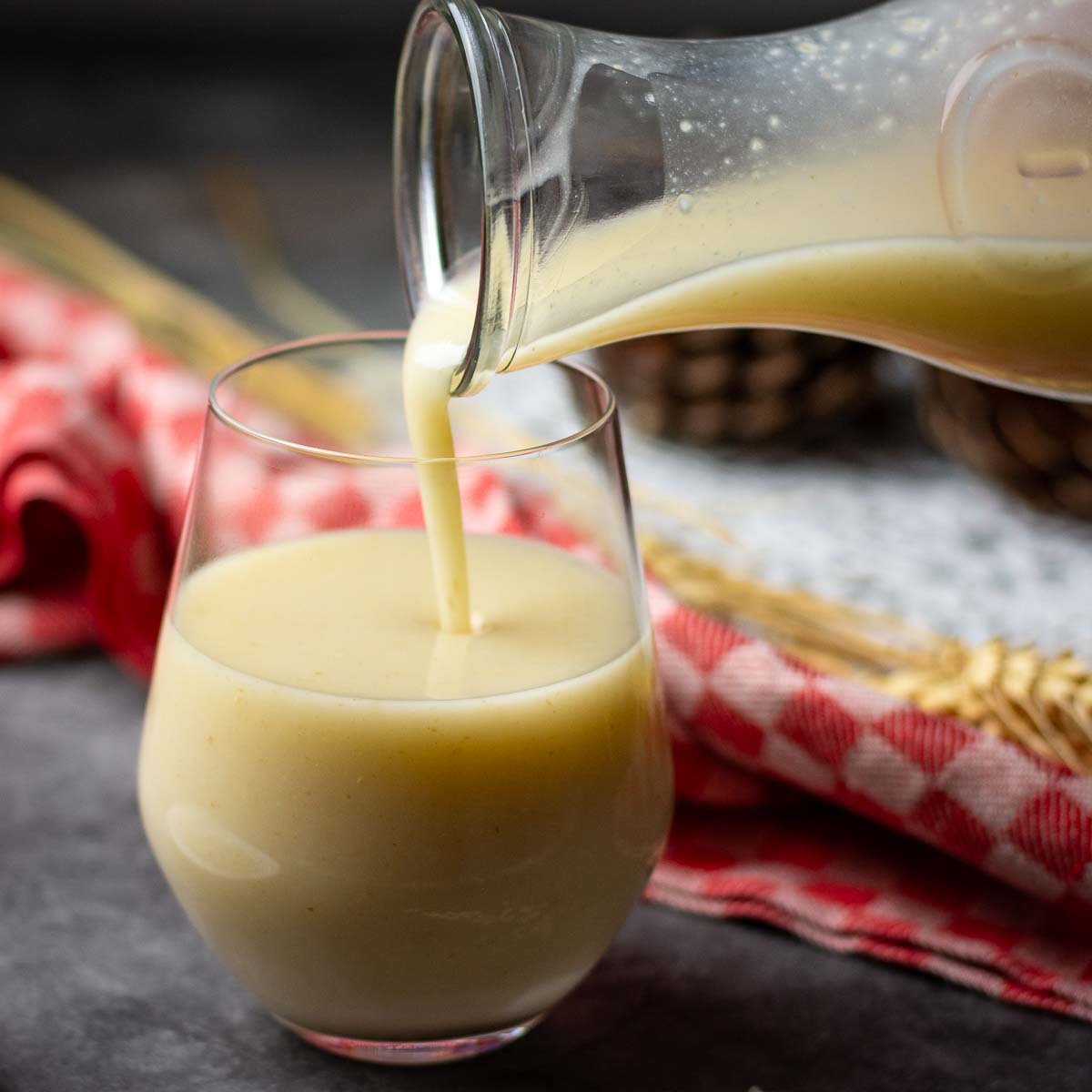 Oat Kissel being poured from a carafe into a glass on a Christmas Eve table in Lithuania.