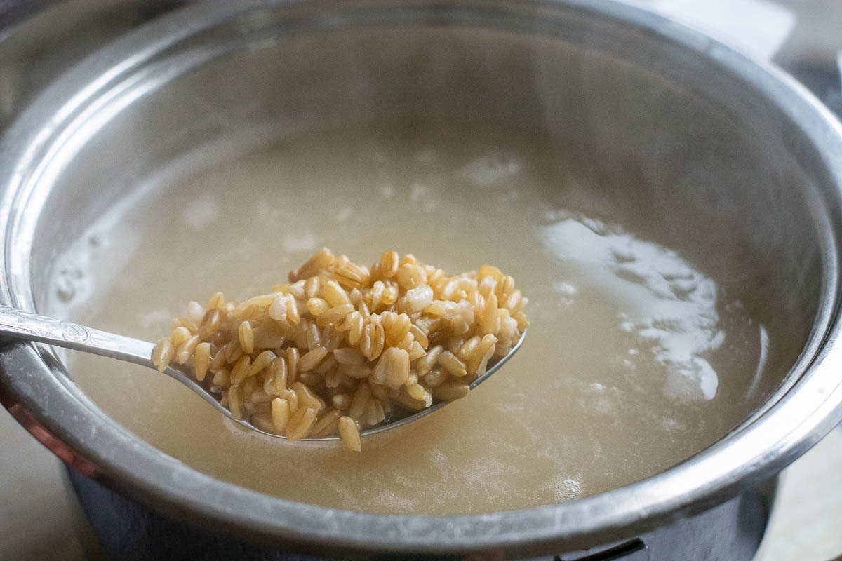 Oat groats cooking in a pot.
