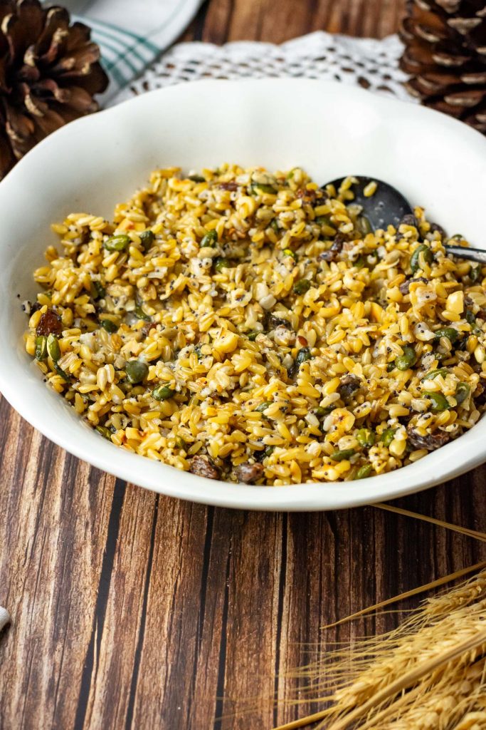 Christmas eve grain bowl in a white bowl on a wooden table.
