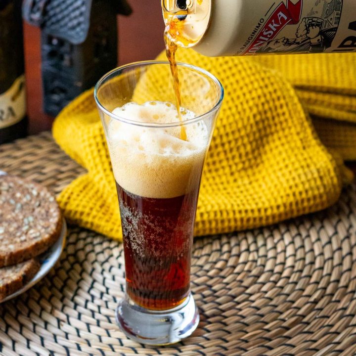 Lithuanian Kvass, known as Gira being poued into a glass from a can.