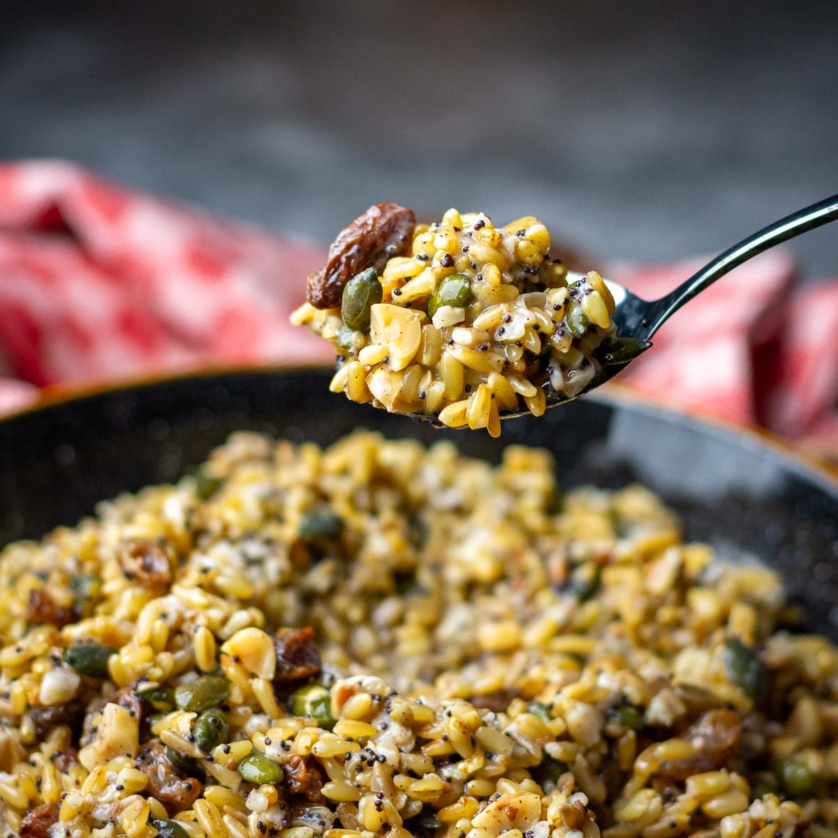 A spoonful of Lithuanian Kucia is being picked up from a bowlful of Chrsitmas eve Grain bowl.