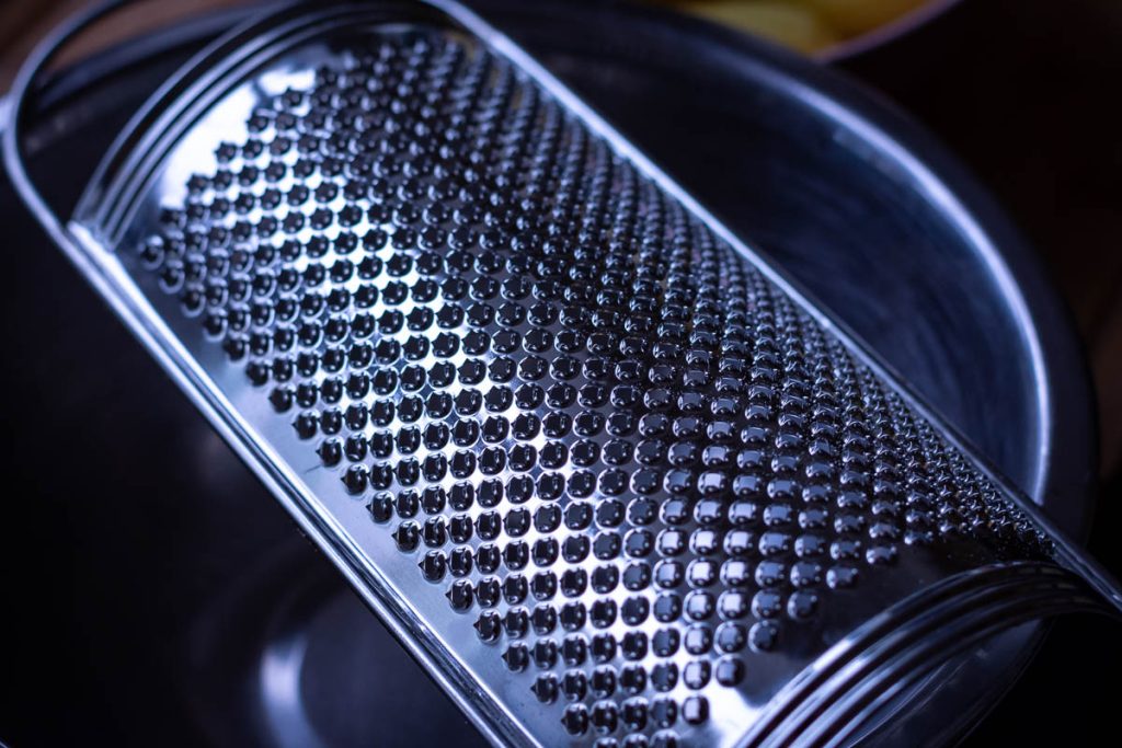 Zester/ parmesan grater side for grating potatoes for pancakes.