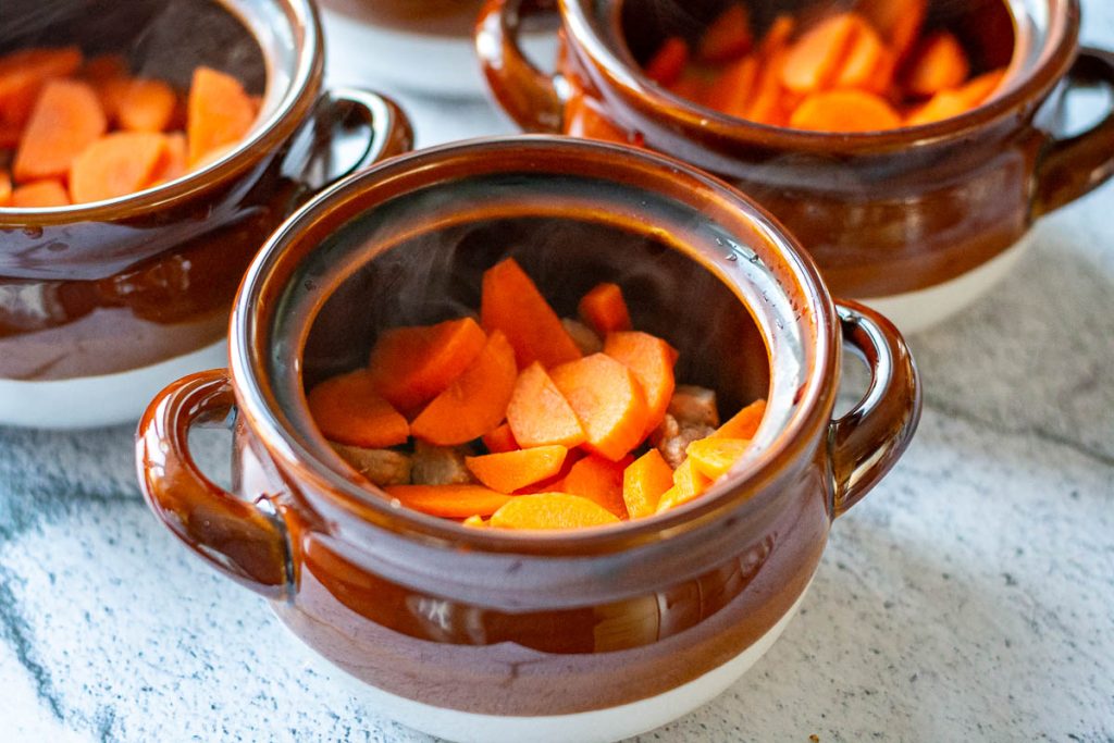 Pork topped with carrot slices.