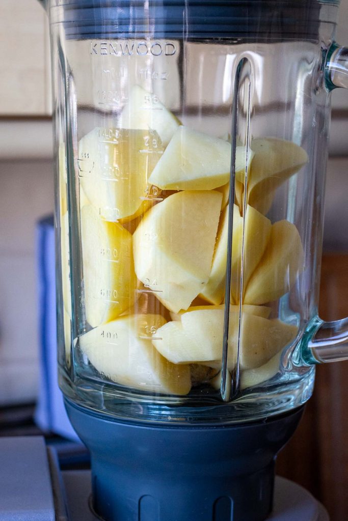 Peeled and chopped potatoes in a large Kenwood liquidiser jug about to be blitzed.