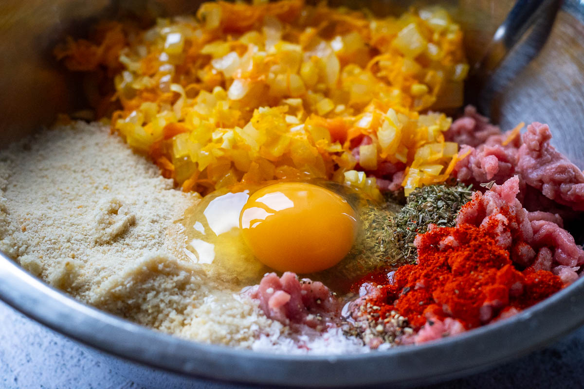 Turkey meatlaf ingredients in a large mxiing bowl, expect for prunes and cheese.