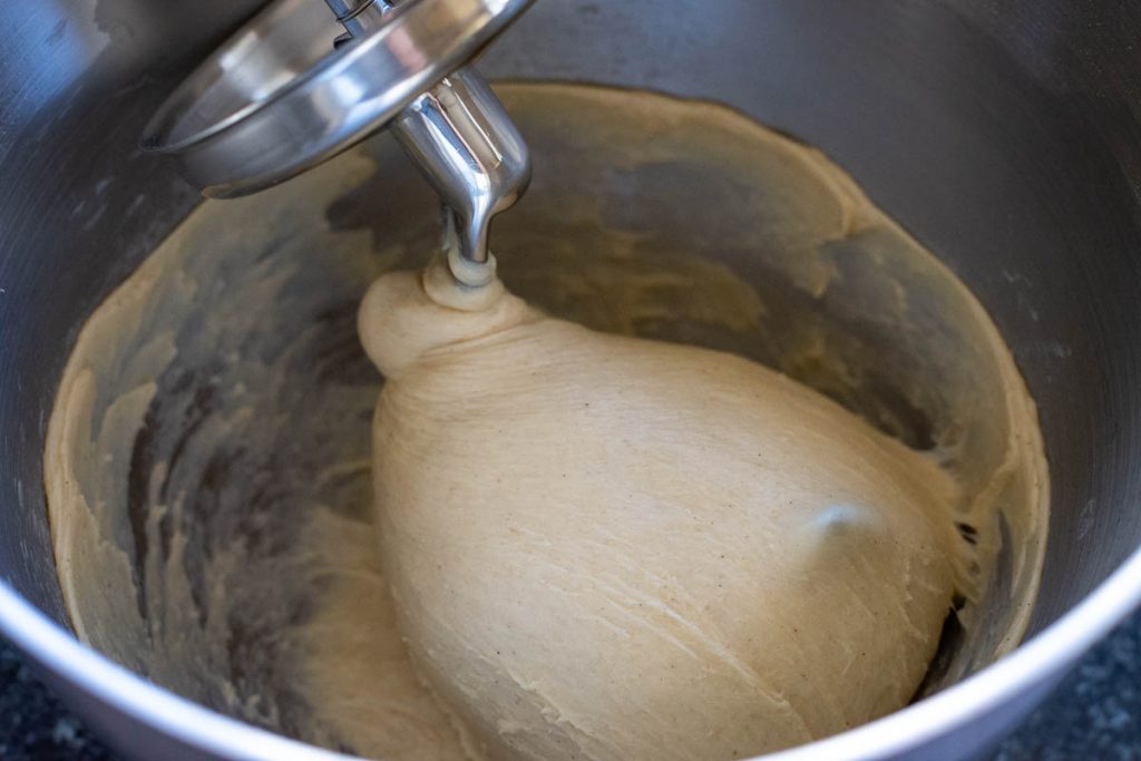 Soft and elastic dough gathering around dough hook attachment in the stand mixer. 