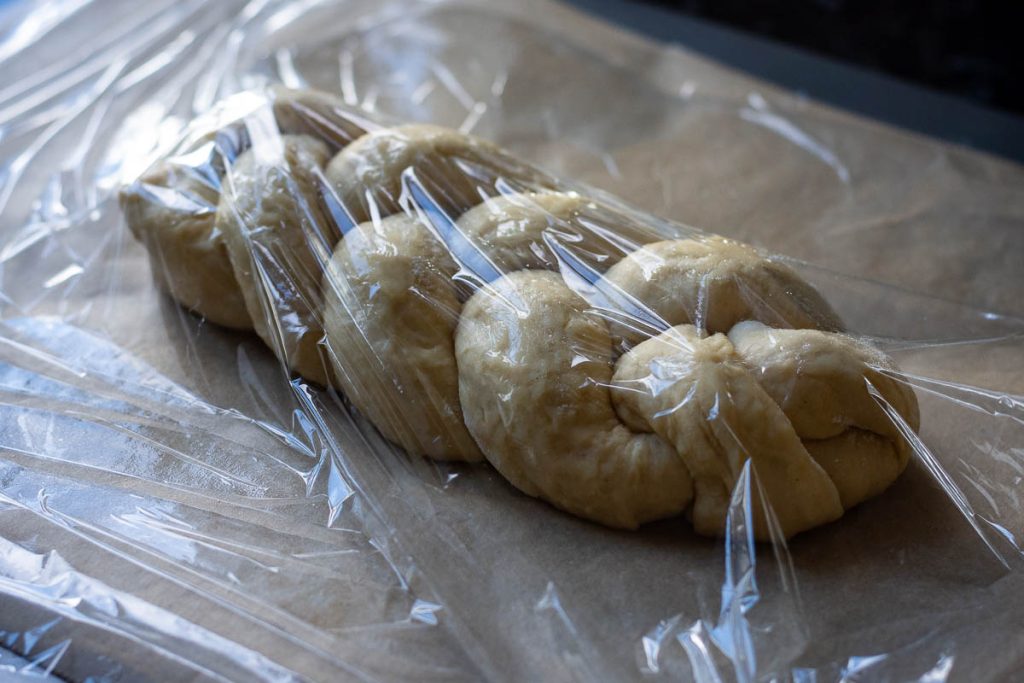 Shaped Easter Bread covered with oiled clingfilm. 