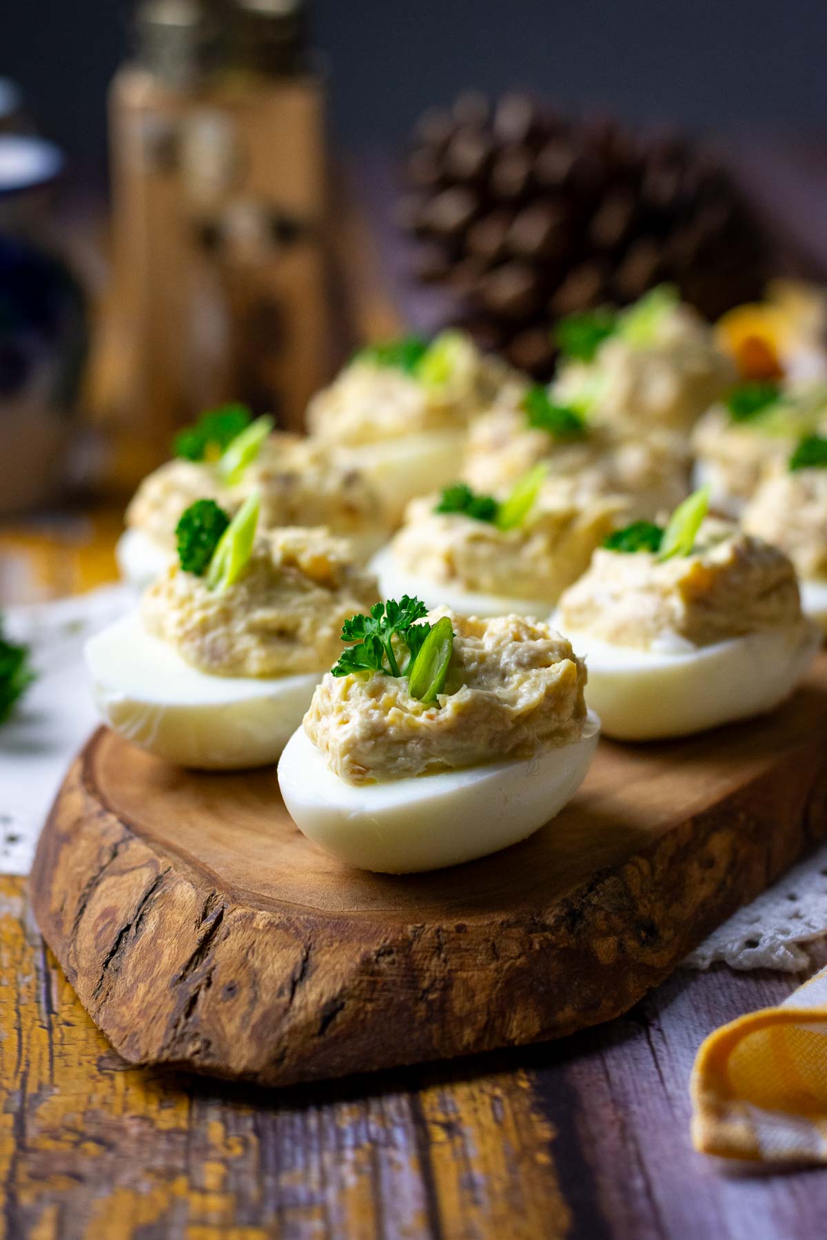 Eggs stuffed with smoked mackerel filling on a wooden board. 
