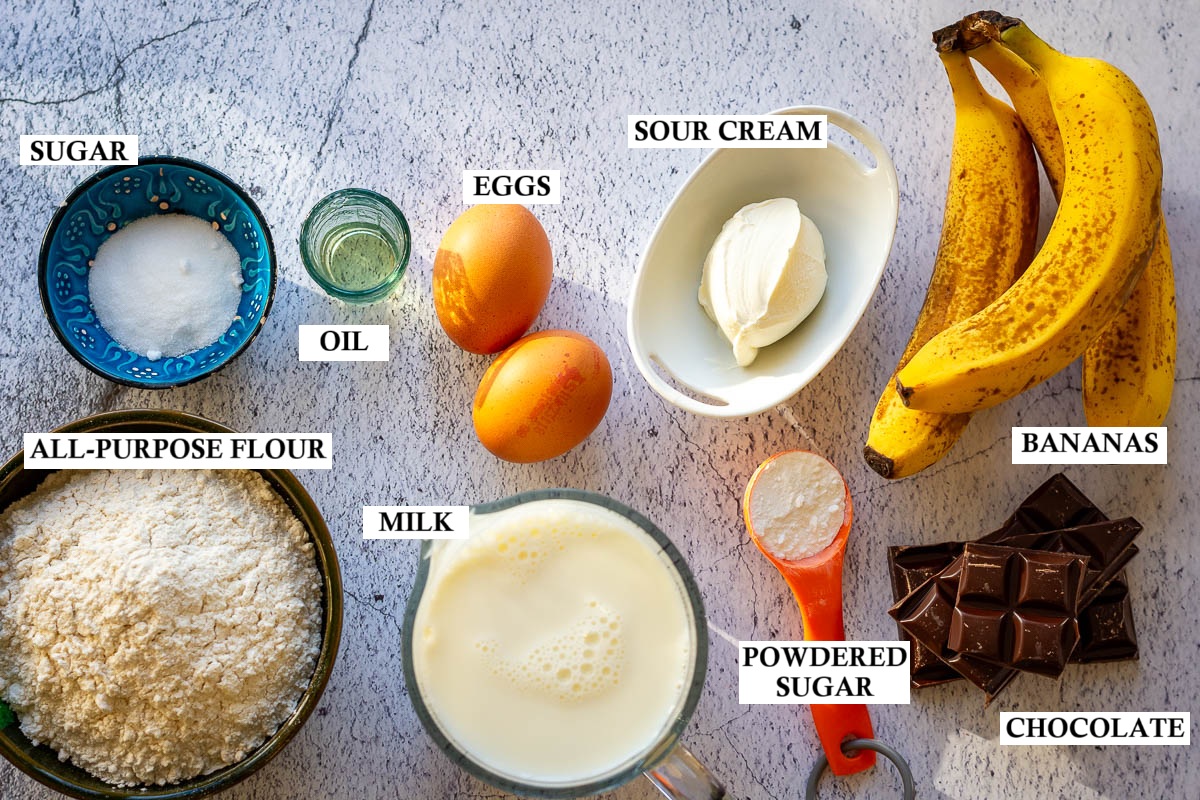 Ingredients for Banana crepes on a light grey surface.