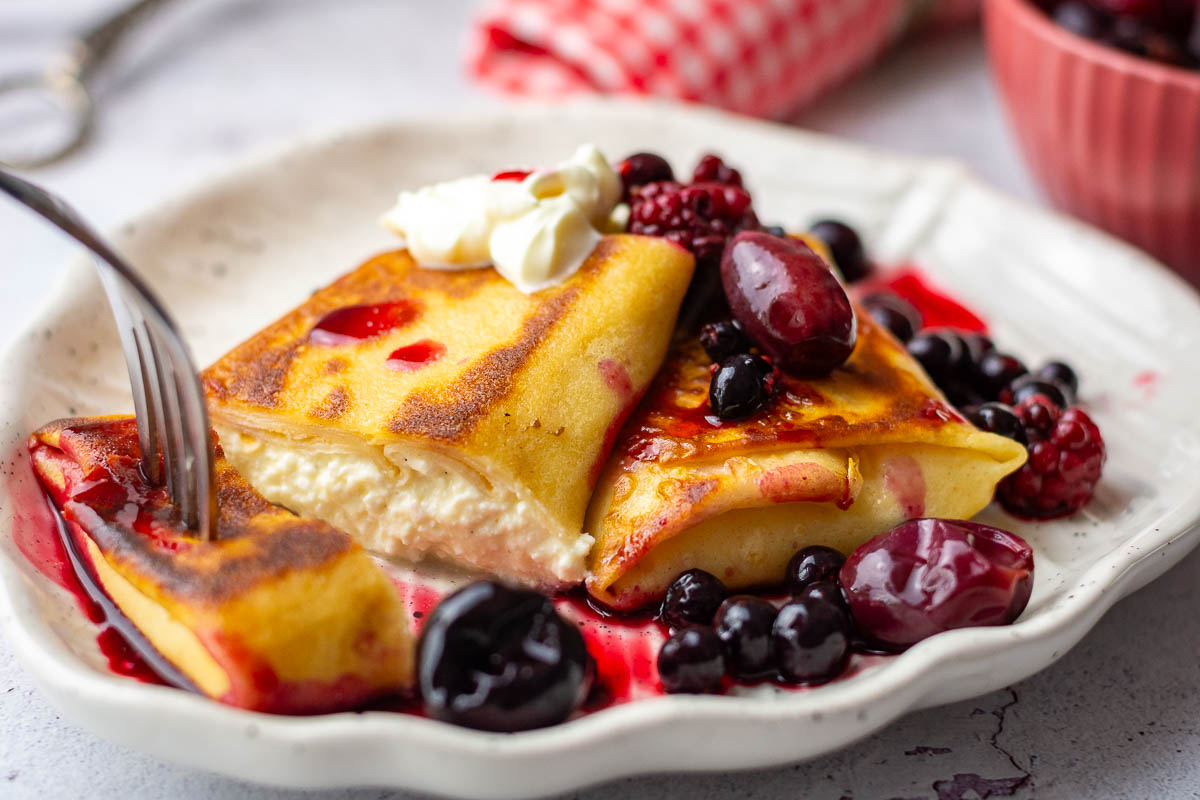 LIthuanian crepes with farmer's cheese served with berry compote and creme fraiche.