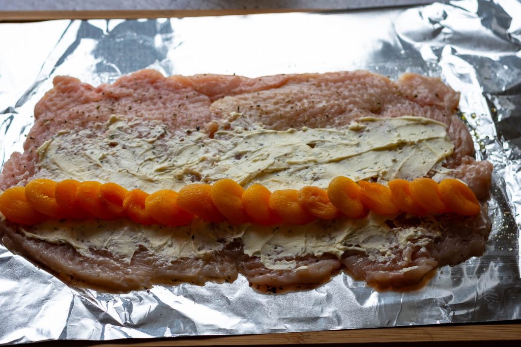 Cheese and apricots on top of chicken.