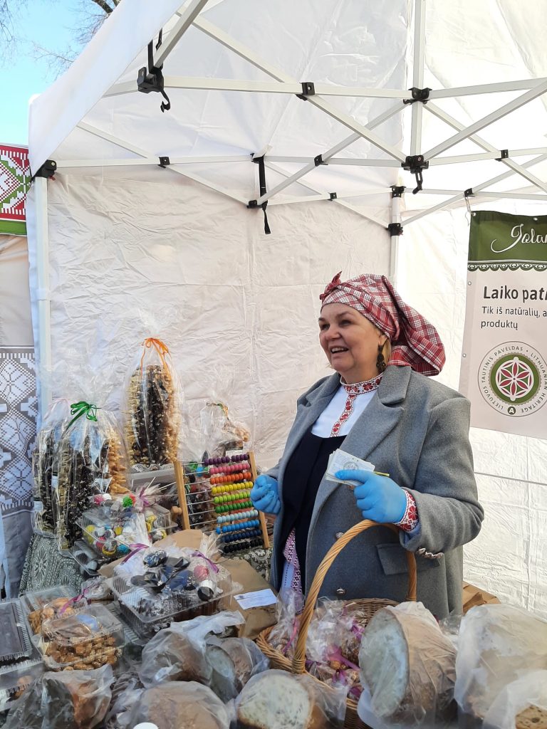 A sales woman in traditional Lithuanian dress in her stall at Kaziuko muge.