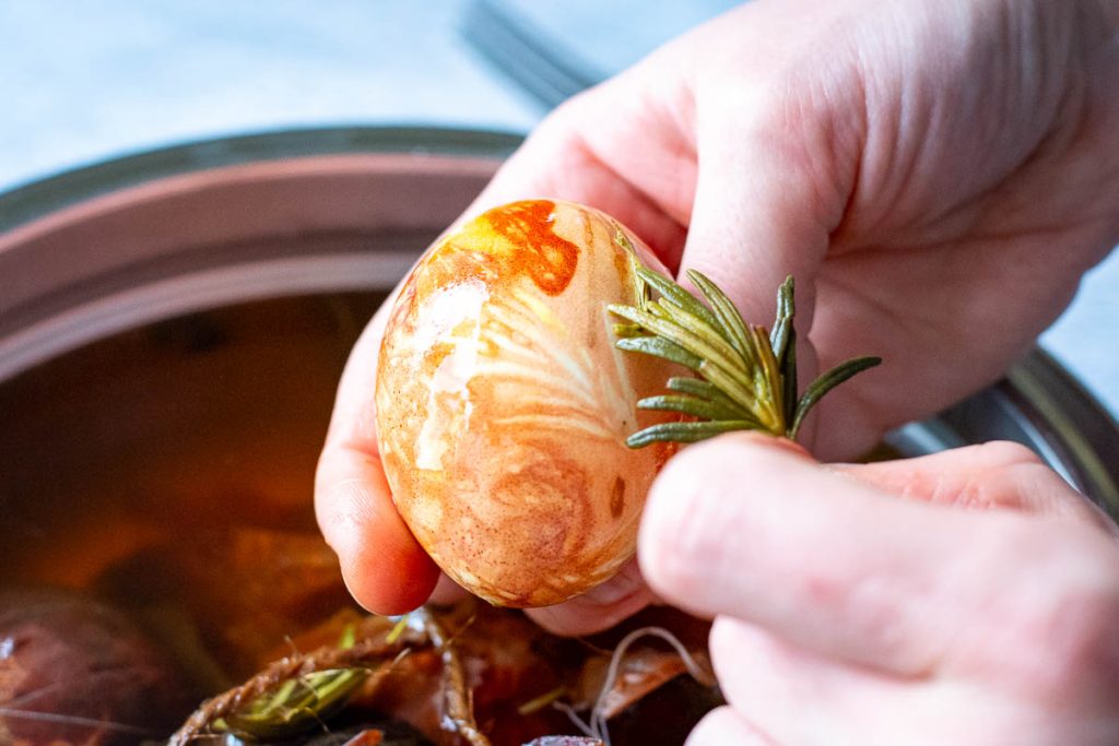 Taking off leaves and flowers off the egg to reveal the patterns. 