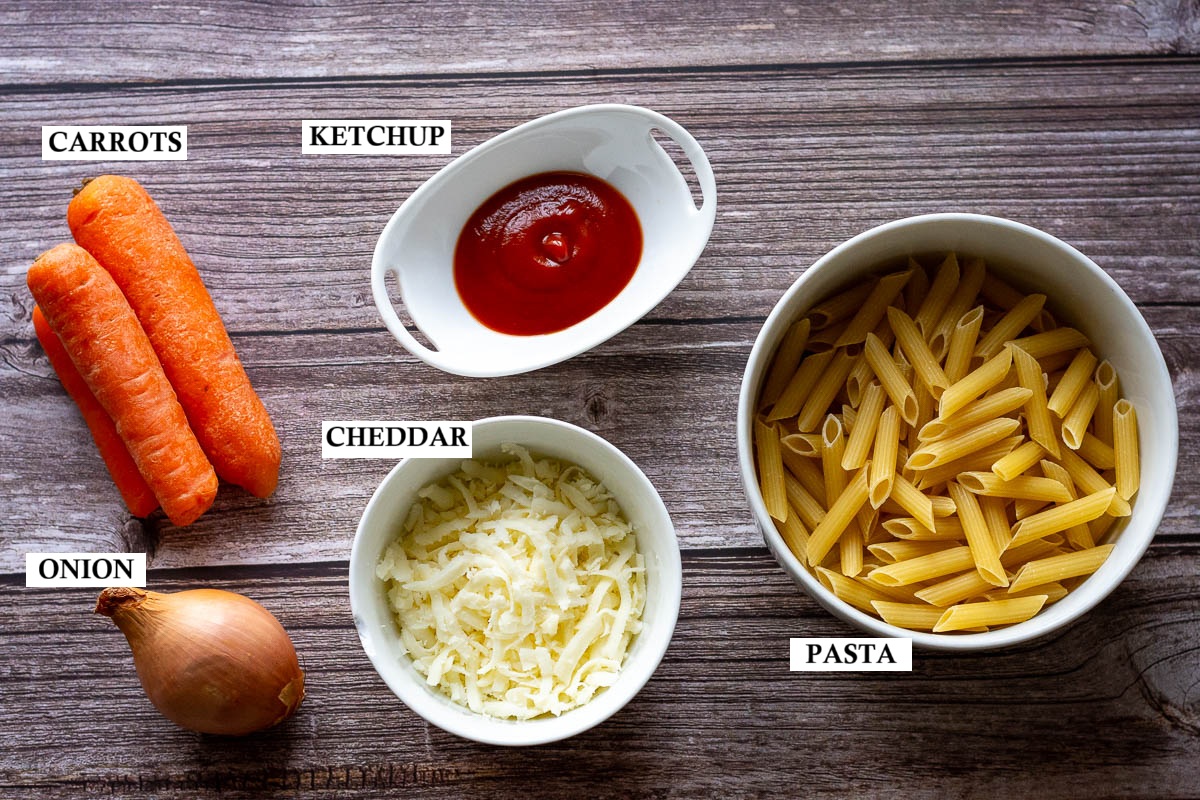 Ingredients for cheesy pasta with carrots and onions.