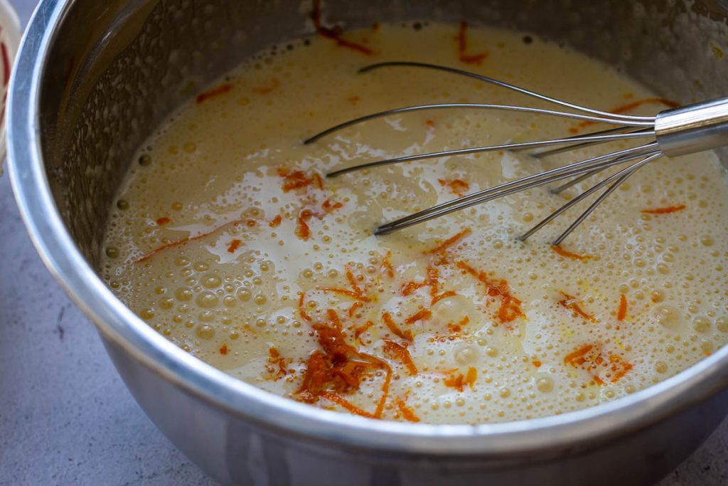 Stiriing the zest and orange juice in. 