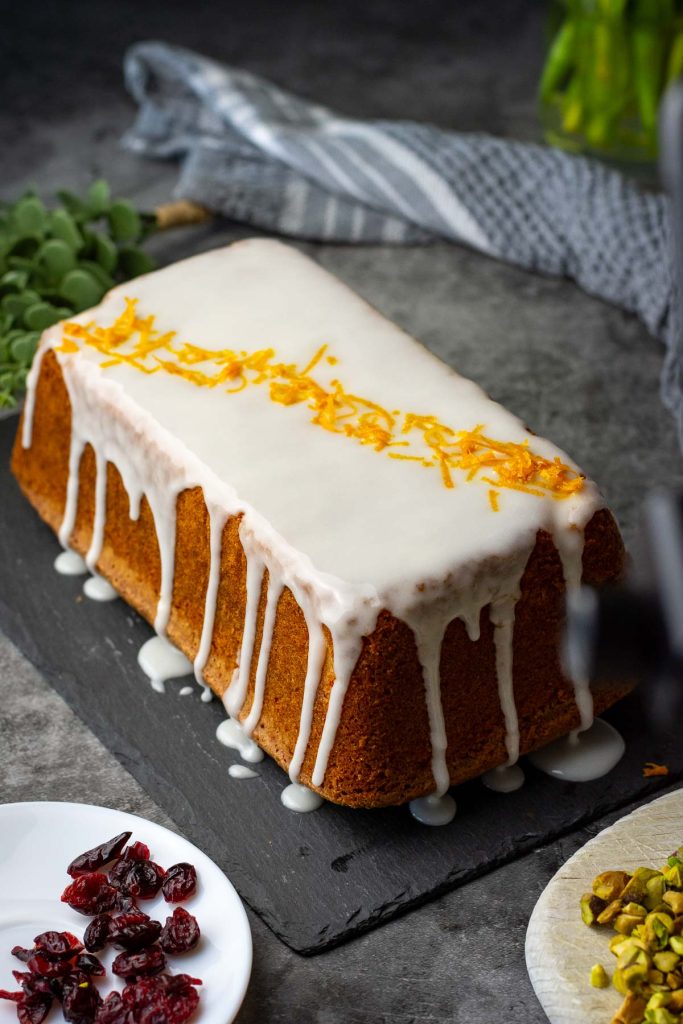 Orange zest scaterred across the length of the cake surface. 