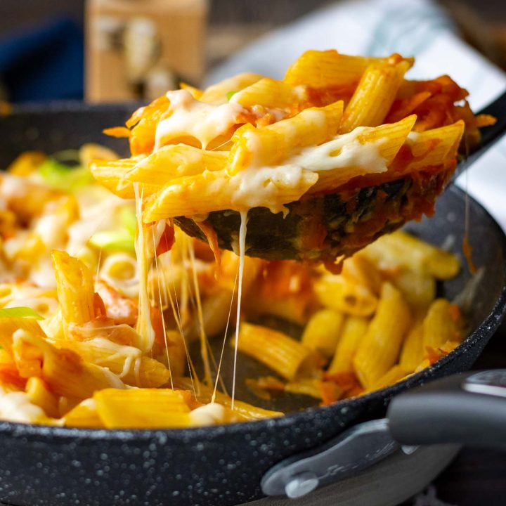 Lithuanian pasta with carrots and onions and cheese strings.