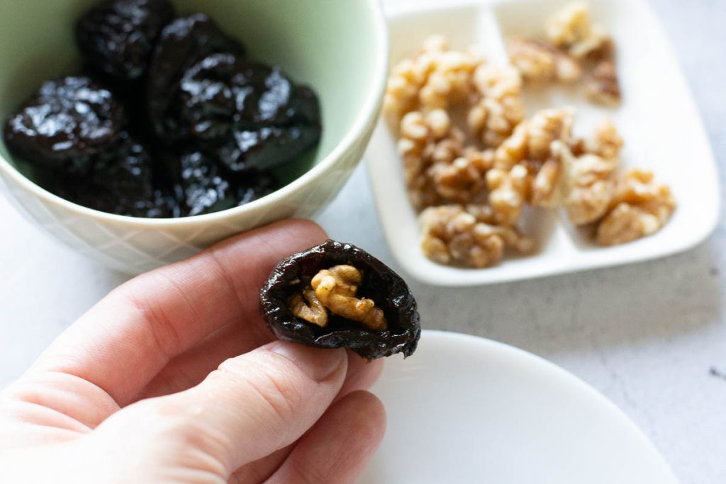 A single walnut stuffed prune held my a hand. 