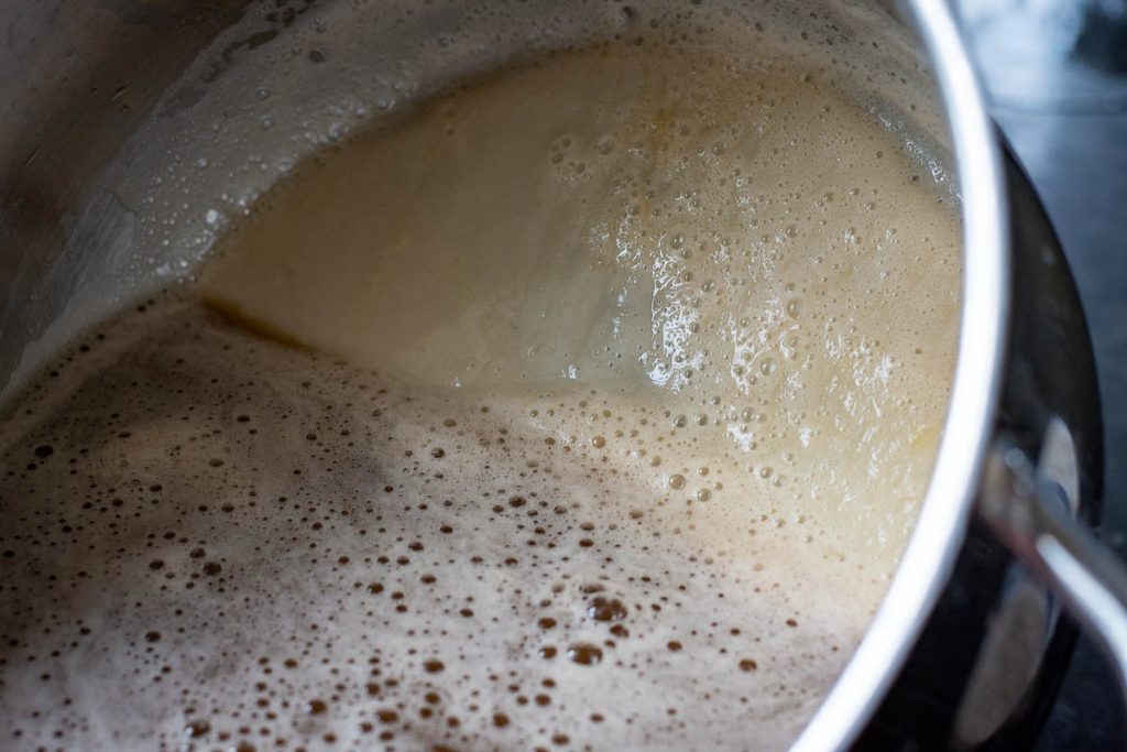 Potato juice settled at the bottom of the pot with potato juice.