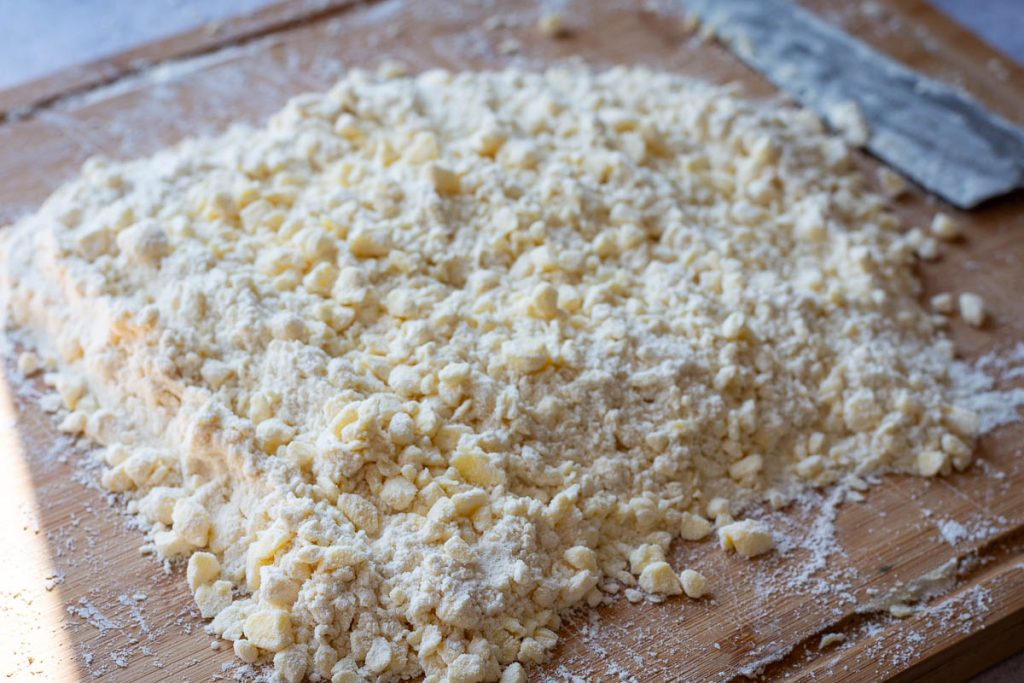 Farmer's cheese crumbled up on top of the flour and butter mixture.