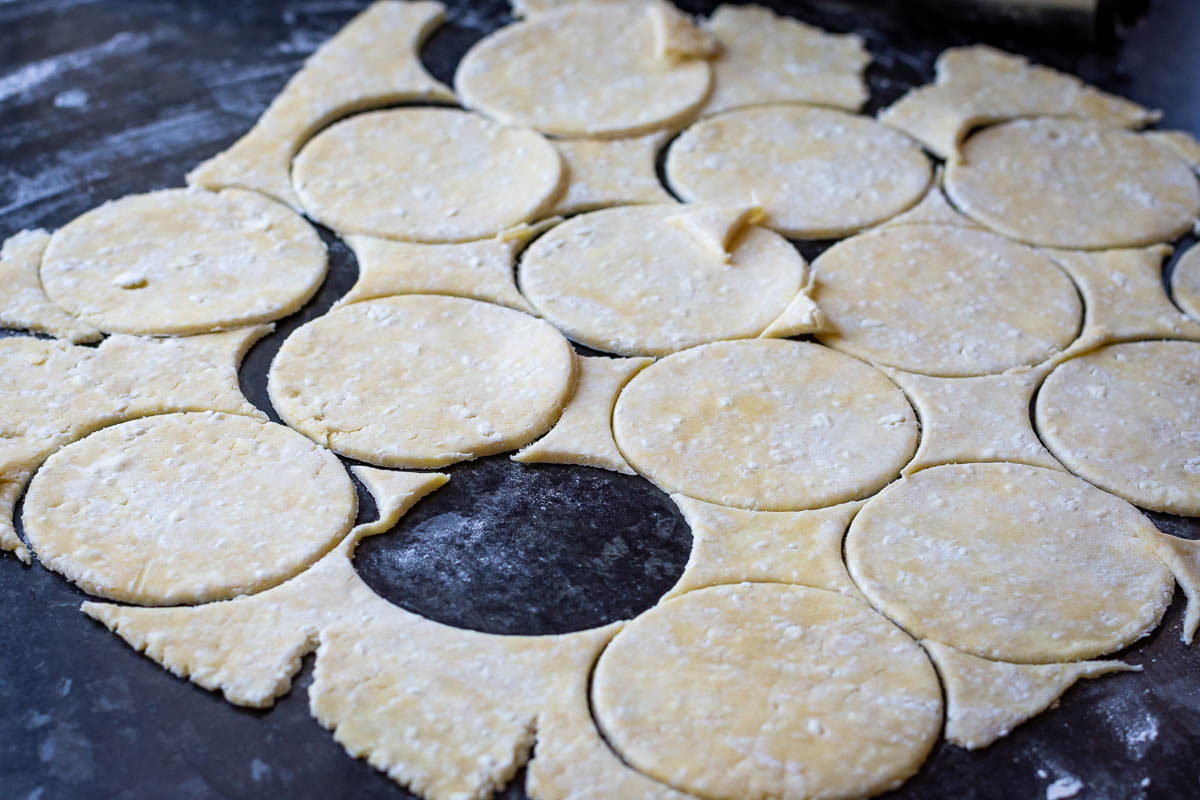 Farmer's cheese cookie dough rolled out thinly and round cookies stamped out.