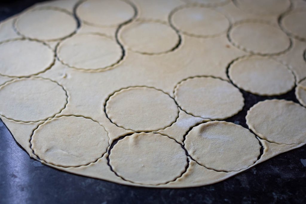 Stamping out rounds of dough for the dumplings.