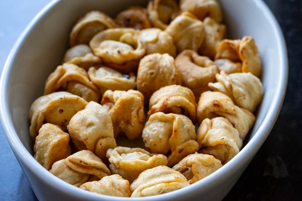 Fried pork dumplings in an overn proof dish in a single layer. 