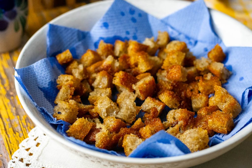 Fried bread in a paperl towel lined bowl. 