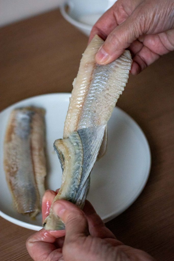 Taking the skin off the herring fillets.
