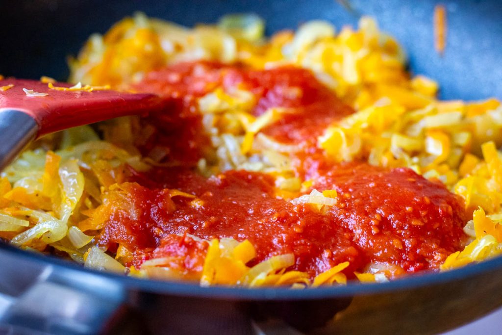Tomato ketchup added to the sauteed vegetables.
