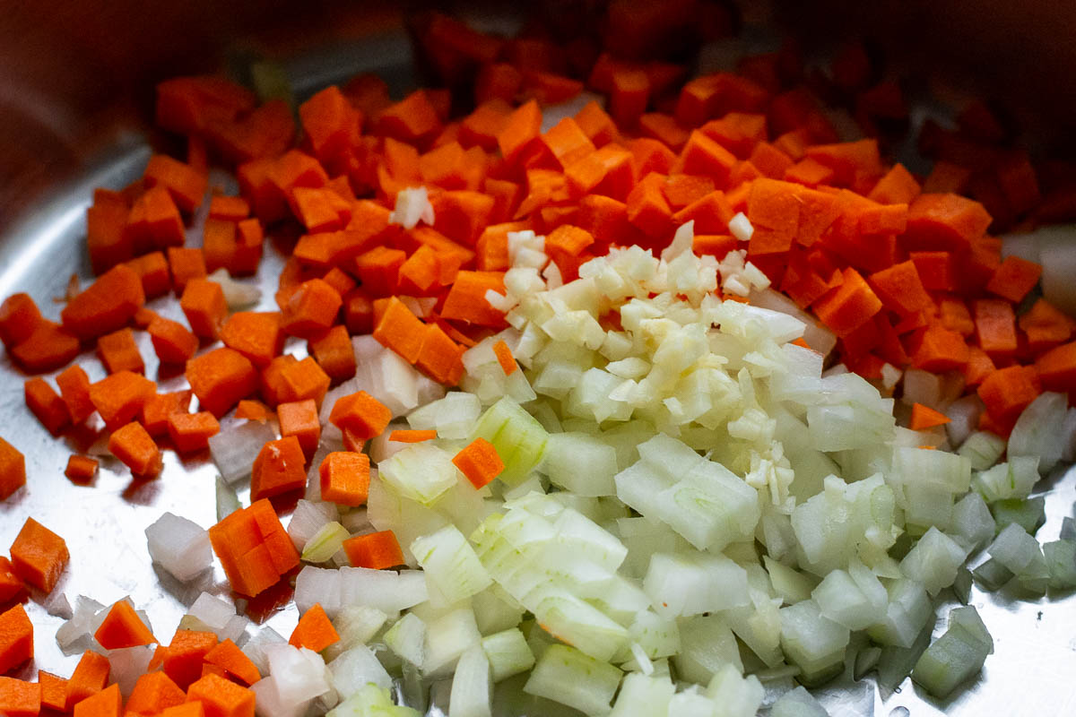 Chopped carrots, onions and garlic in a pan with oil. 