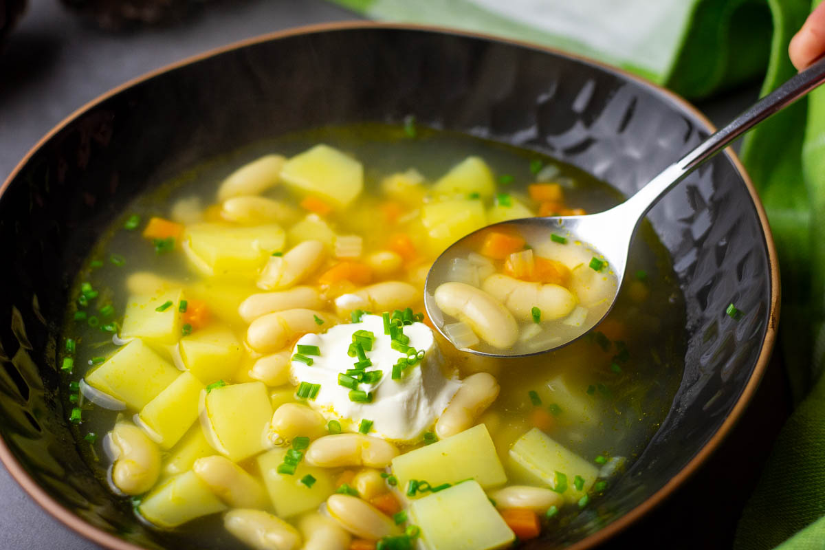 Lithuanian white bean soup with sour cream on top. 