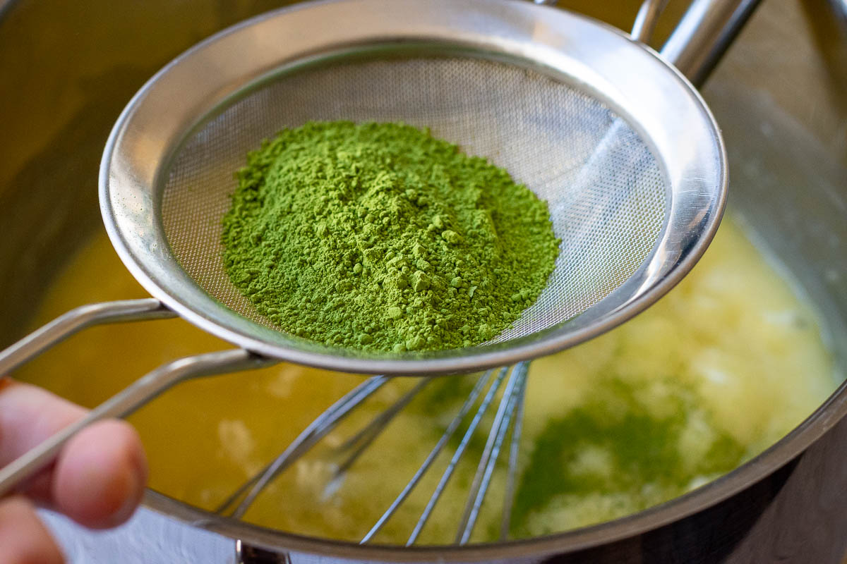 Matcha powder in a fine mesh sieve.