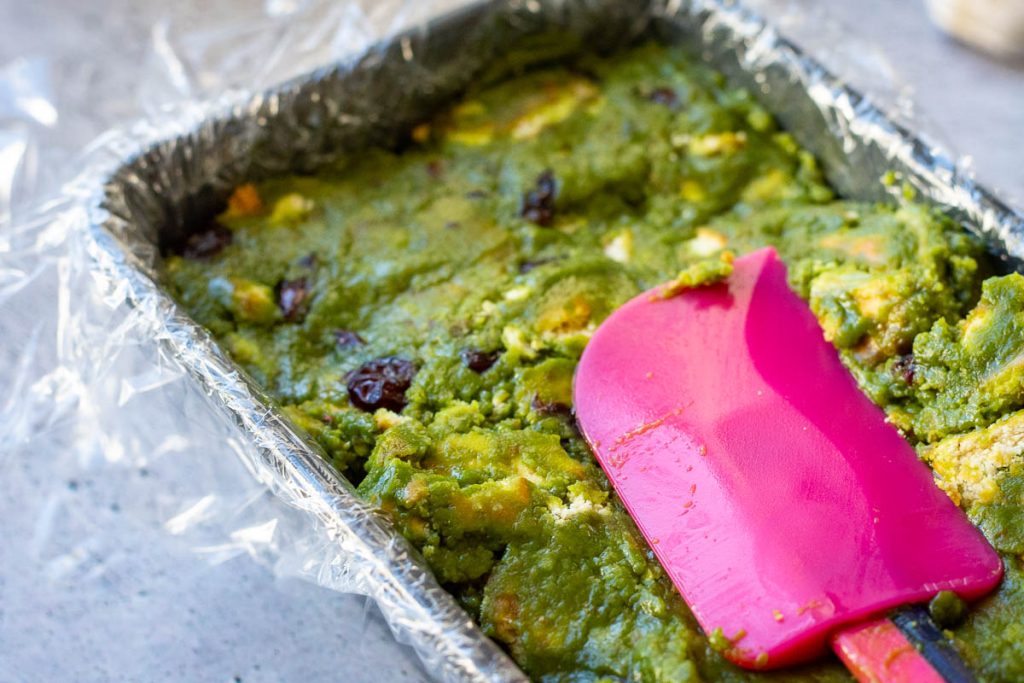 Pressing the mixture to compress with a rubber spatula.