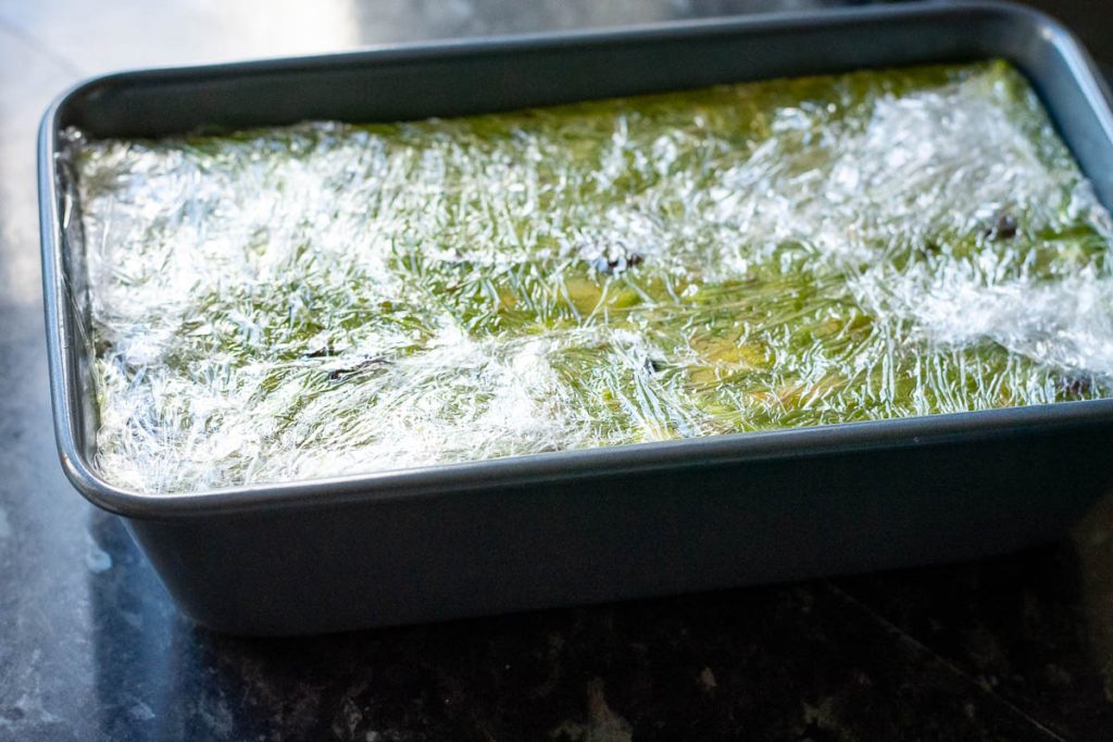 Matcha Tinginys wrapped in plastic wrap.