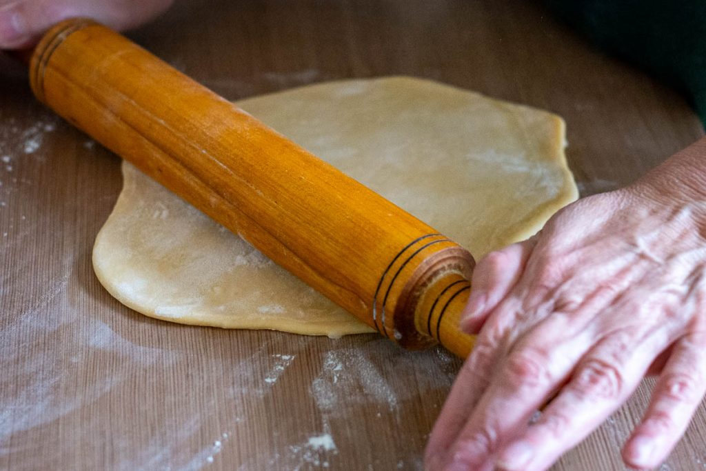 Rolling the anthill dough into a thin sheet.